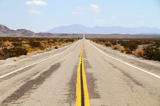 Long desert highway leading into Mojave Desert, California, USA