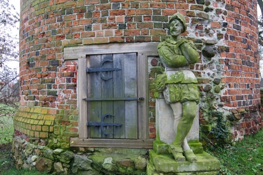 Stone city guard in front of a tower