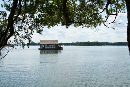 Houseboat under the trees on the Scharmützelsee