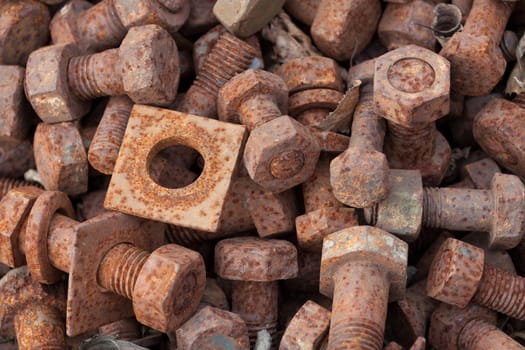 Rusty bolts with nuts in a box