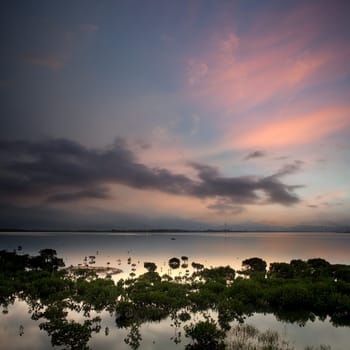 morning lake landscape with sunrise over mountains
