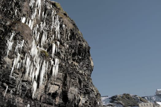 icicles on a cliff face melting in ballybunion ireland on a winters day