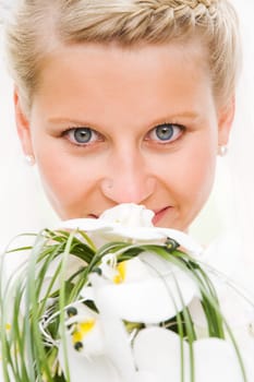 Blonde bride with very beautiful eyes with veil and bridal bouquet