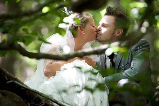 Bride and groom with wedding dress and suit in nature