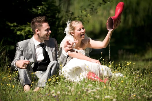 Bride and groom with wedding dress and suit in nature