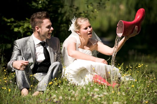 Bride and groom with wedding dress and suit in nature