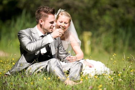 Bride and groom with wedding dress and suit in nature