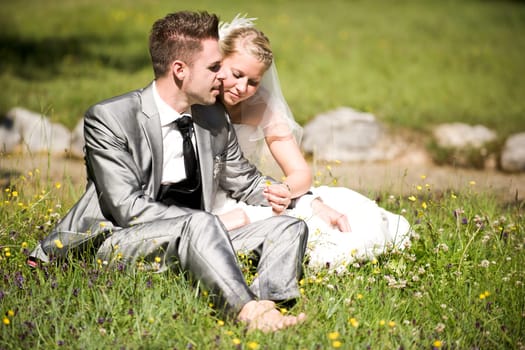 Bride and groom with wedding dress and suit in nature