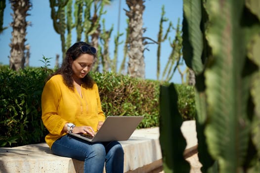 Confident portrait of purposeful female developer, programmer, freelance entrepreneur typing text on laptop keyboard. People. Education. Online business. Communication. Remote work and career concept