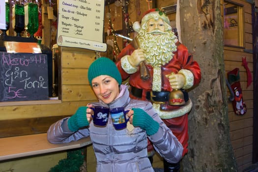 girl in the Christmas market holding mugs with mulled wine Luxemburg