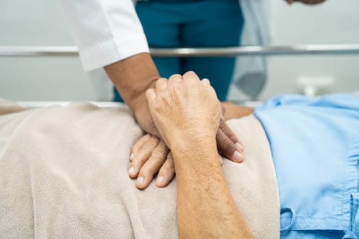 Doctor checking senior patient woman lie down on a bed in the hospital, healthy strong medical concept.