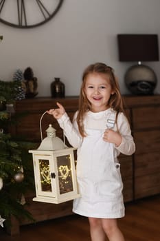 Girl holding a lantern with lights
