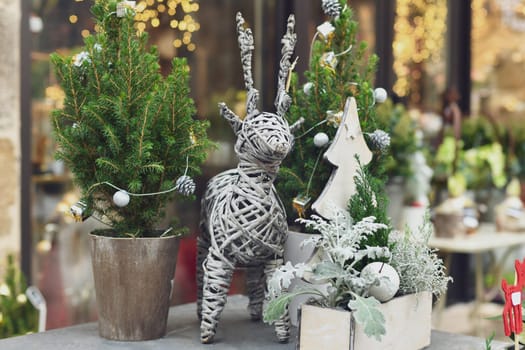 Decorated Christmas tree in a white pot in a shop