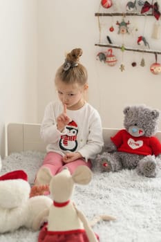 A girl playing in a room with the plush toys