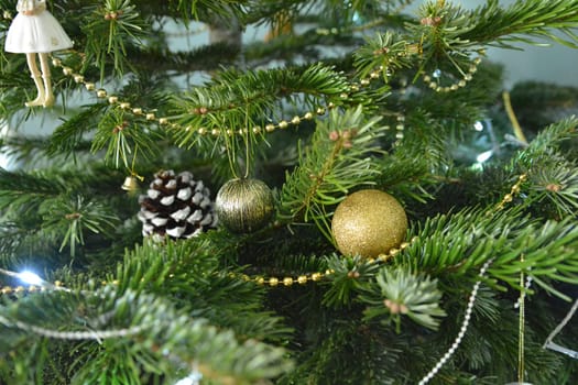 Gold decoration toys and cone on the Christmas tree