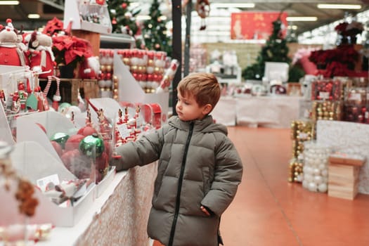 A boy choose the toys for the Christmas tree