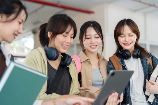 university students using a digital tablet while walking to next class.