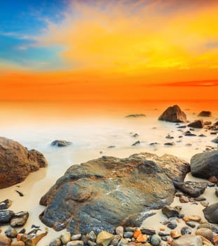 Sunrise over the sea. Stone on the foreground