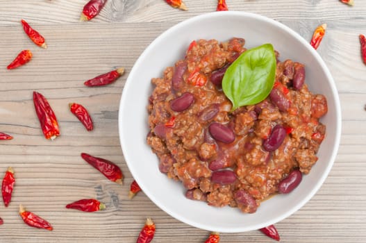 Chilli Con Carne in White Bowl and Chili Peppers