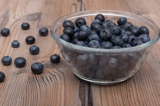 Glass Bowl of Blueberries on Wooden Table