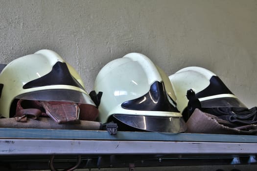 White fire figters helmets has unique helmet  shapes