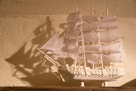 Small souvenir ship is white and on shelf