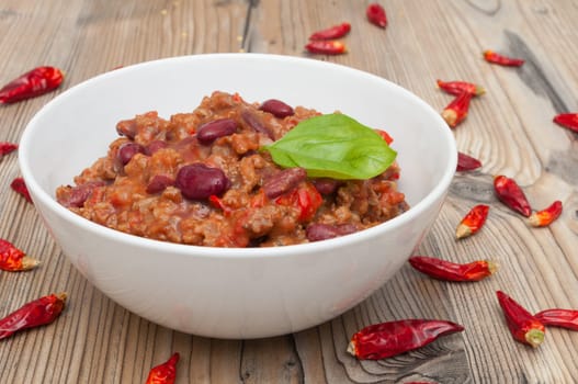 Chilli Con Carne in White Bowl and Red Chili Peppers