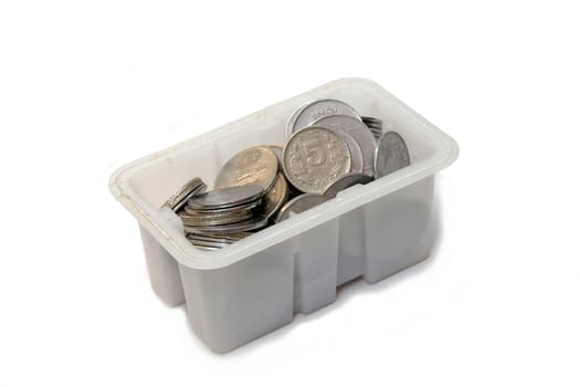 White plastic box containing coins isolated on white