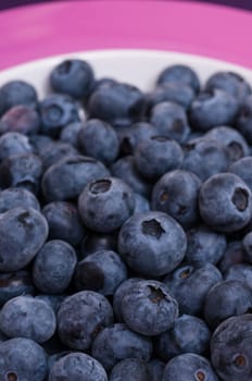 Close-up of blueberries in a plate and in portrait format