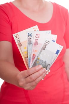 A female hand holds euro bills in front