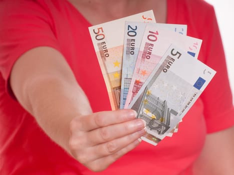 Female hand holding euro bills as money compartment in front