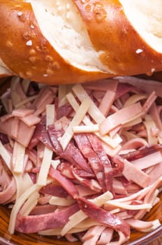 Sausage salad of Lyon,beef tongue and Emmental with pretzel rolls