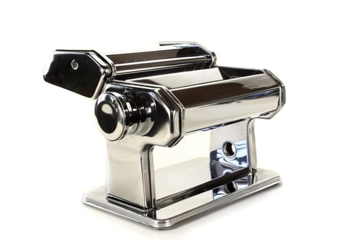 a pasta machine against a white background