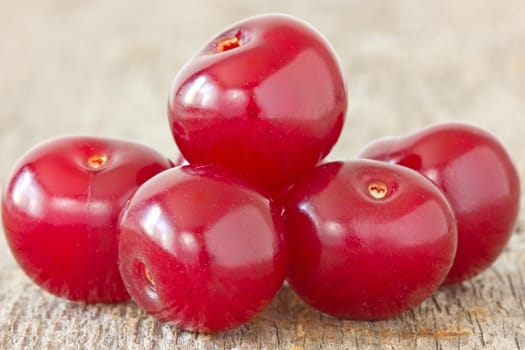 pile of cherries  on the old wooden background