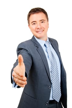 Confident business man holding out hand in friendly hand shake gesture on isolated background