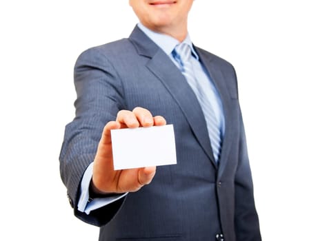 Business person in suit holding out blank white copy space card on isolated background. Focus on card.