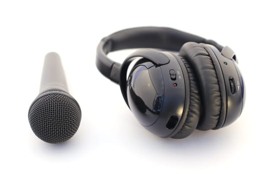 Audio equipment: microphone and headphones over white