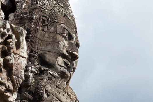 Massive stone faces decorating towers of Bayon temple in Angkor Thom, Cambodia