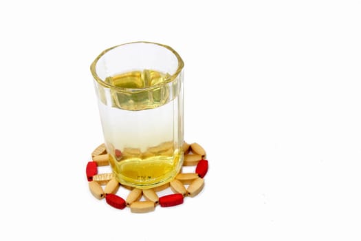 Glass tumbler containing light yellow juice, isolated on white