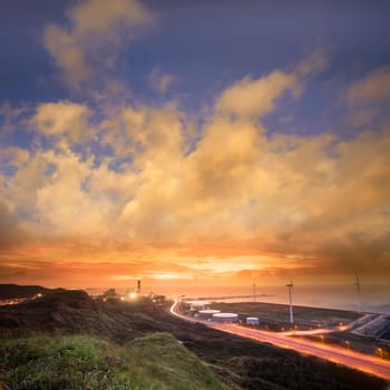 A road and windmills during sunset, made with a wide angle lens