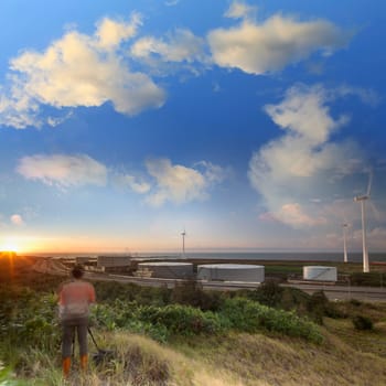 A road and windmills during sunset, made with a wide angle lens