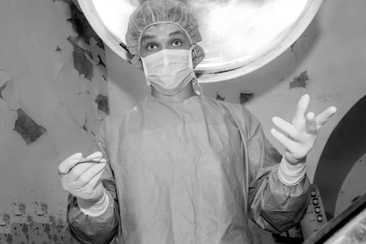 Shaded surgeon ask camera before coming difficult surgery