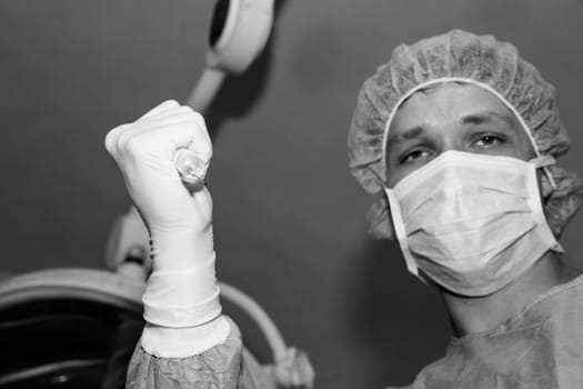 Shaded surgeon making injection before coming difficult surgery