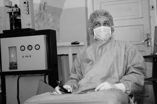 Shaded surgeon take tool before coming difficult surgery