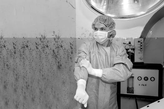 Shaded surgeon prepare clothes before coming difficult surgery