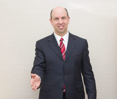 Business man offering a handshake.