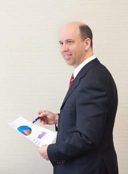 Smiling business man with document.