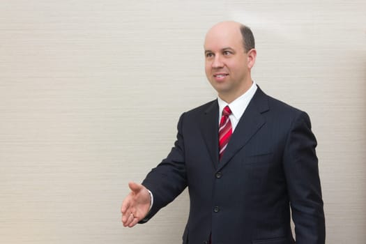 Business man offering a handshake.