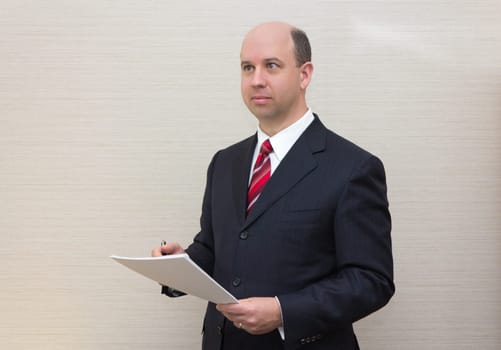 Business man holding a document.