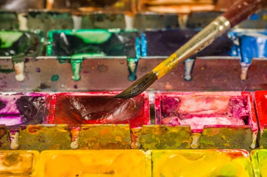 Watercolor paints with brush